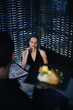 Woman looking at her meal being served by waiter