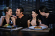 Two couples having dinner together