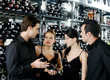 Two couples choosing wine in the wine cellar