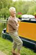 Senior woman pulling houseboat