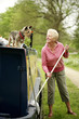 Senior woman looking at her dog while mopping her houseboat