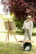 Photo: Senior man painting in the park Senior man painting in the park