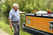 Senior man pulling his houseboat