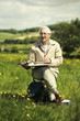 Foto: Senior man sitting on the chair drawing Senior man sitting on the chair drawing