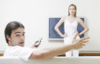 Woman blocking the television while her boyfriend is watching it