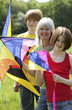 Woman and her children holding kites