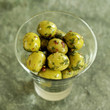 Glass of fresh Italian olives on a slate