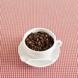 Fresh espresso coffee beans in a cappuccino cup