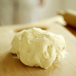 Pizza dough on wooden board