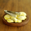 Photo: Fresh tortellini pasta on wooden board showing spinach and ricotta filling with pasta tongs on top Fresh tortellini pasta on wooden board showing spinach and ricotta filling with pasta tongs on top