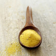 Dried Italian polenta on wooden spoon