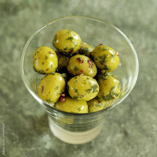 Photo: Glass of fresh Italian olives on a slate Glass of fresh Italian olives on a slate