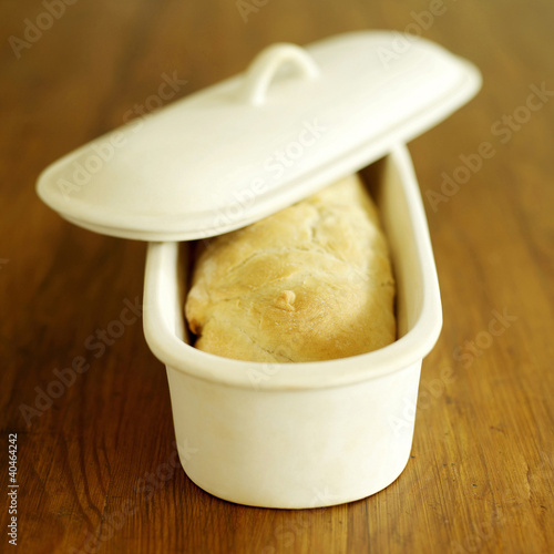 Photo: Fresh Italian ciabatta in ciabatta crock with lid on top Fresh Italian ciabatta in ciabatta crock with lid on top