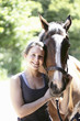 Woman posing with her horse