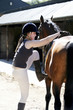 Woman trying to get on a horse
