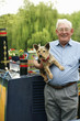 Foto: Senior man posing with his dog on the houseboat Senior man posing with his dog on the houseboat