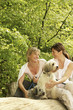 Women and their dogs hanging out in the park