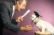 Foto: Senior man presenting a scroll to his dog Senior man presenting a scroll to his dog