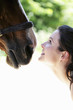 Foto: Woman smiling while looking at her horse Woman smiling while looking at her horse