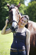 Woman posing with her horse