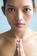 Closeup portrait of a young woman praying