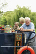Foto: Senior couple and their pet dog on the houseboat Senior couple and their pet dog on the houseboat