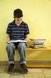 Boy sitting on the bench reading book