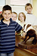 Boys and girls posing with model bear in the classroom