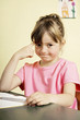 Girl thinking while sitting at her table
