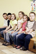 Boys and girls sitting together on a bench
