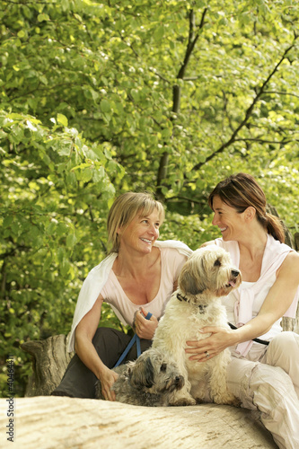 Photo: Women and their dogs hanging out in the park Women and their dogs hanging out in the park