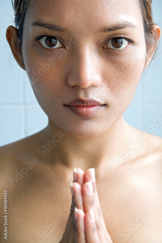 Photo: Closeup portrait of a young woman praying Closeup portrait of a young woman praying