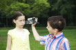 Boy recording images of girl making a face