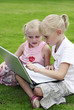 Foto: Girls using the laptop Girls using the laptop