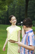 Photo: Boy recording images of girl Boy recording images of girl