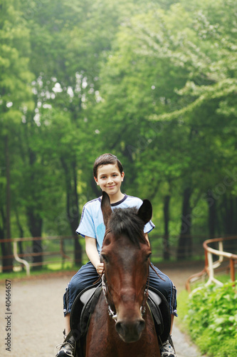 Photo: Boy riding a horse Boy riding a horse