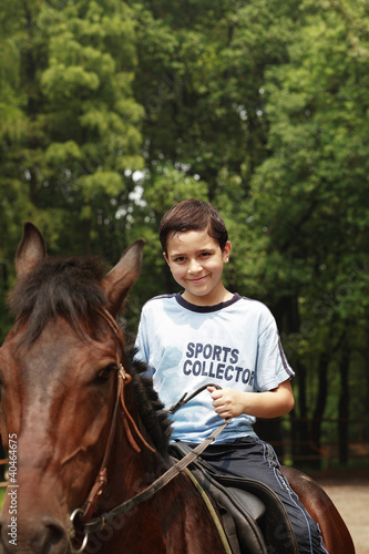 Foto: Boy riding a horse Boy riding a horse