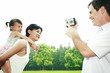 Man recording images of his wife and daughter