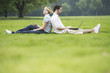 Photo: Young couple sitting back to back each other Young couple sitting back to back each other