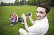 Photo: Man recording images of boy and girl Man recording images of boy and girl