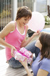Girls receiving presents from friend
