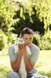 Young man holding a cat in his arms