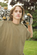 Young man carrying a skateboard