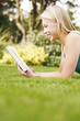 Young woman reading a book on the grass