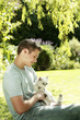 Young man holding a cat in his arms