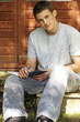 Young man writing in a book