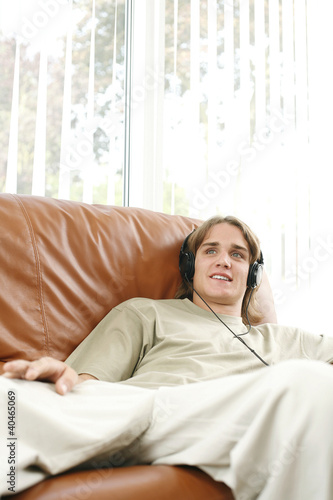 Photo: Young man listening to music Young man listening to music