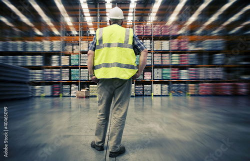 Photo: Man looking at warehouse goods Man looking at warehouse goods
