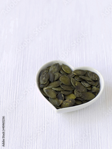 Photo: Pumpkin seeds in a heart-shaped bowl Pumpkin seeds in a heart-shaped bowl
