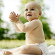 Baby boy smiling while clapping his hands